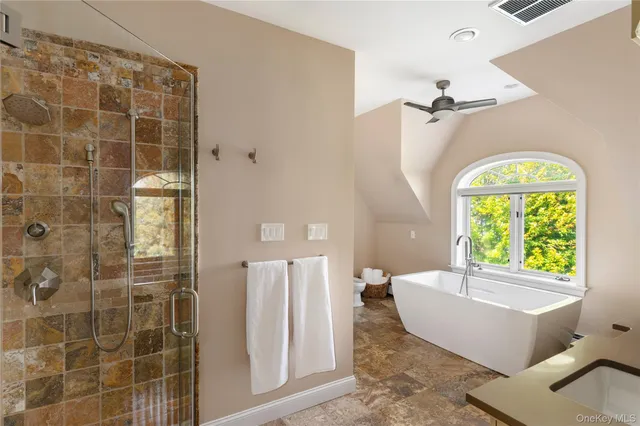 a spacious bathroom with a bathtub and a shower