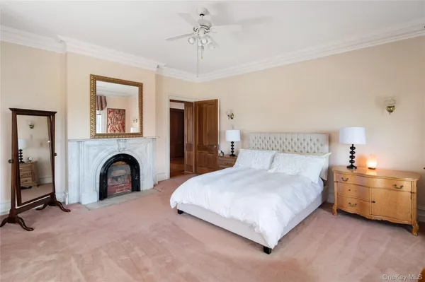 a spacious bedroom with a bed and a fireplace