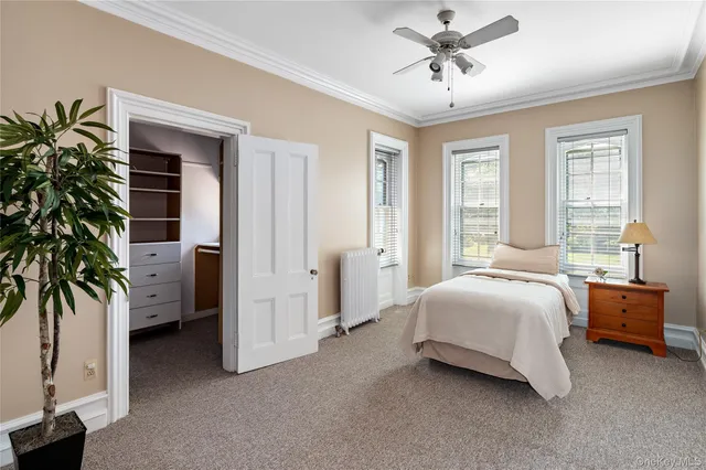 a spacious bedroom with a bed and a chandelier