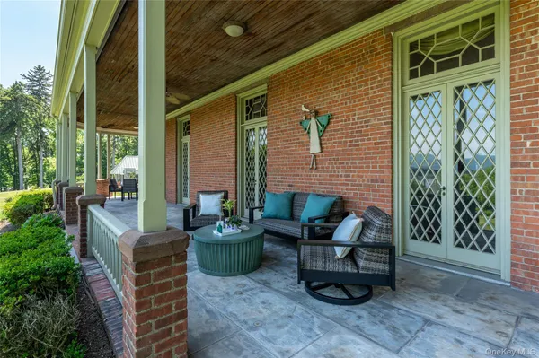 a view of a patio with couches and a potted plant