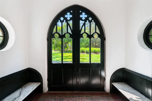 a living room with windows and a floor to ceiling window