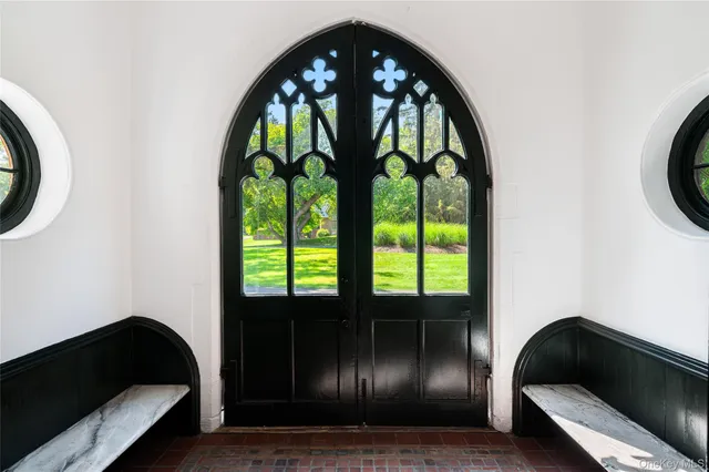 a living room with windows and a floor to ceiling window