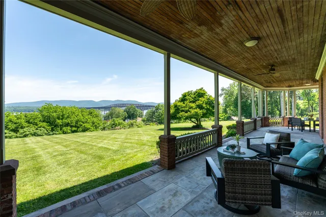 a view of a two chairs in the patio next to a yard