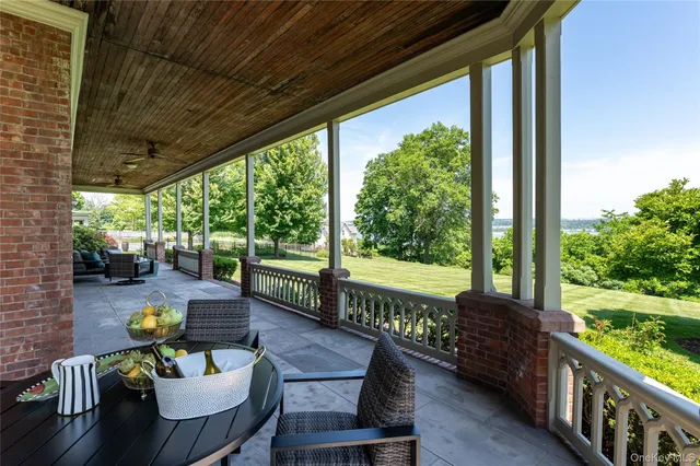 a view of a patio with couches chairs and wooden floor
