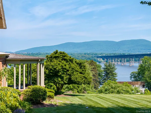 a view of a house with a garden and a pond