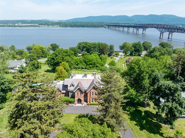 an aerial view of a house with a lake view