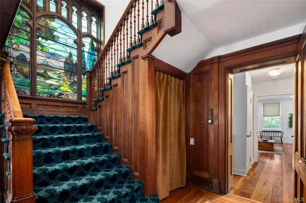 a view of entryway with wooden floor and stairs