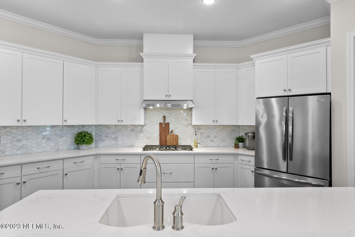 110 Pine Manor Drive Jacksonville, FL 32081 - Photo 12 of 55 a kitchen with a sink a refrigerator and cabinets