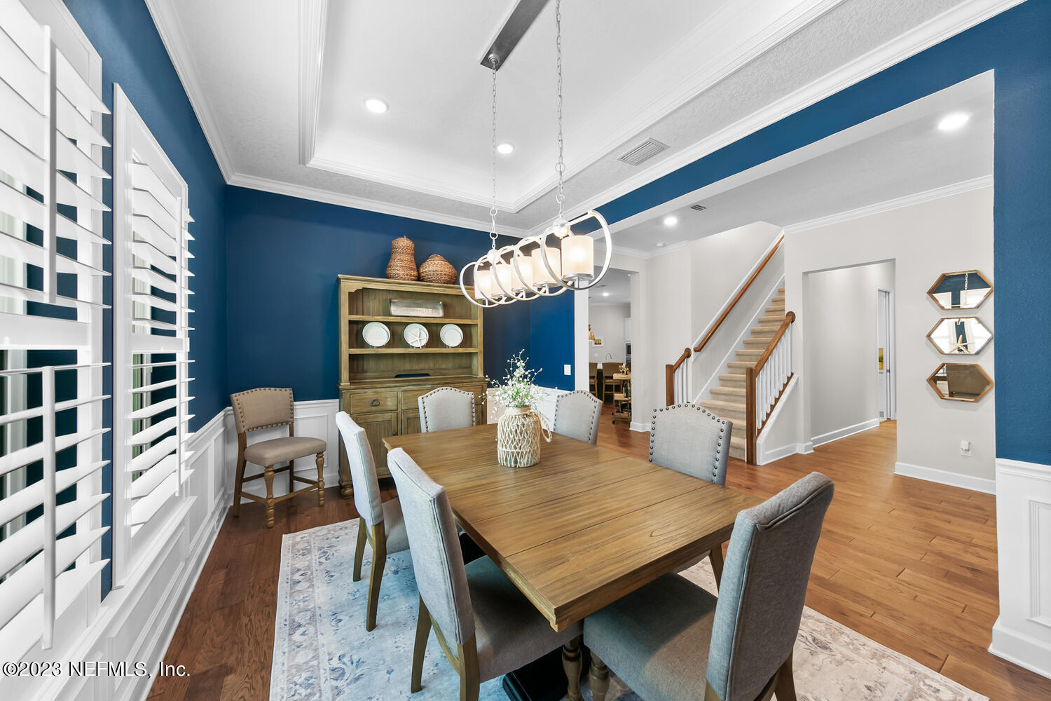 110 Pine Manor Drive Jacksonville, FL 32081 - Photo 15 of 55 a dining room with wooden floor a chandelier a wooden table and chairs
