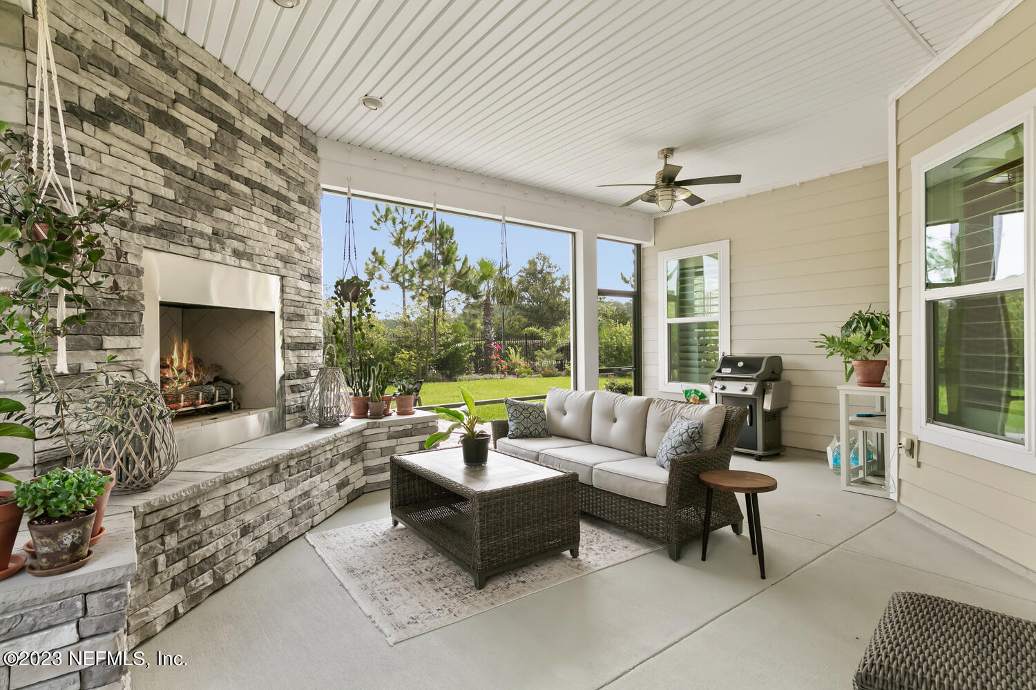 110 Pine Manor Drive Jacksonville, FL 32081 - Photo 30 of 55 a living room with furniture large windows and a flat screen tv