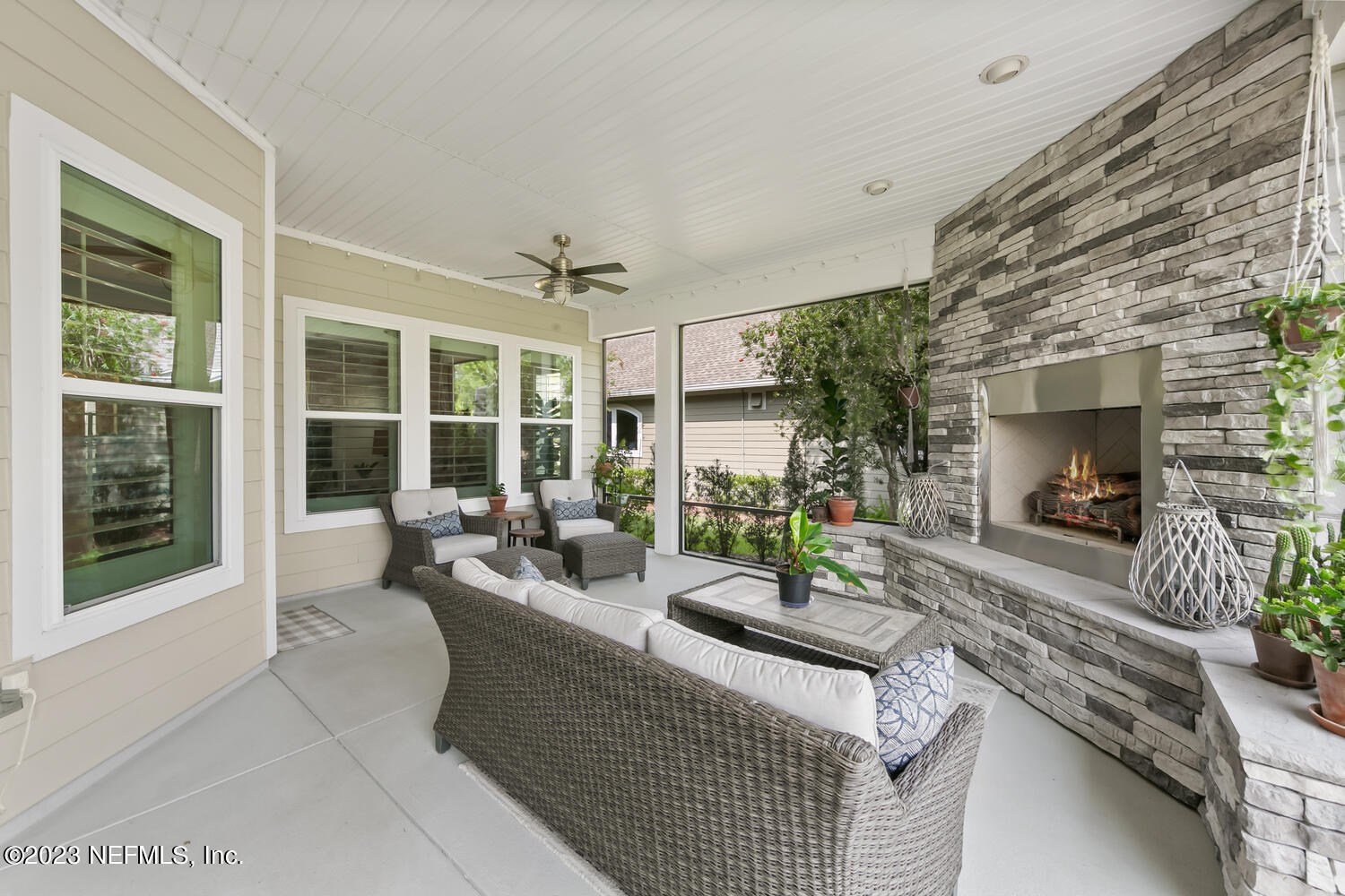 110 Pine Manor Drive Jacksonville, FL 32081 - Photo 31 of 55 a living room with furniture potted plant floor to ceiling window and potted plants