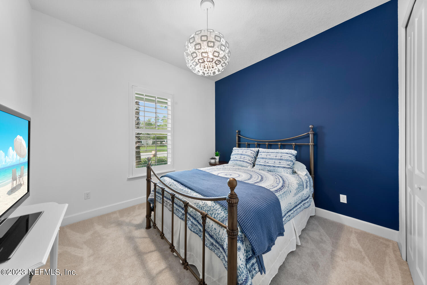 110 Pine Manor Drive Jacksonville, FL 32081 - Photo 38 of 55 a bedroom with a bed and a chandelier