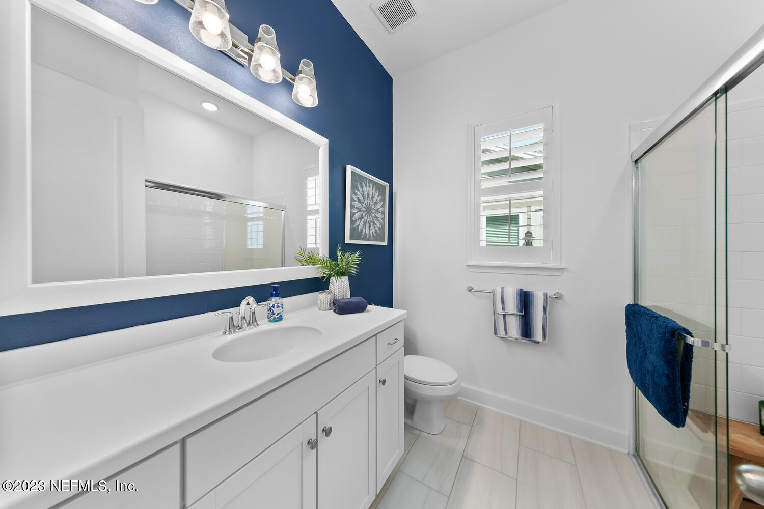 110 Pine Manor Drive Jacksonville, FL 32081 - Photo 39 of 55 a bathroom with a double vanity sink a toilet a mirror and shower