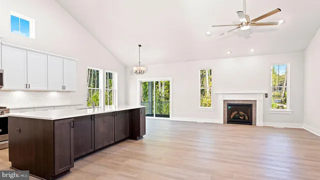 a view of a kitchen with a sink a fireplace and a window
