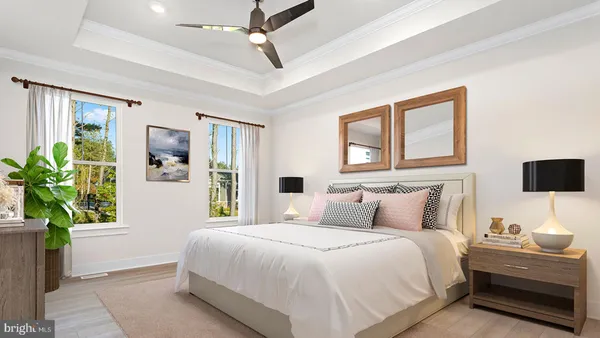 a bedroom with a bed table and a window