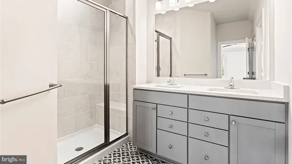 a bathroom with a shower sink and mirror