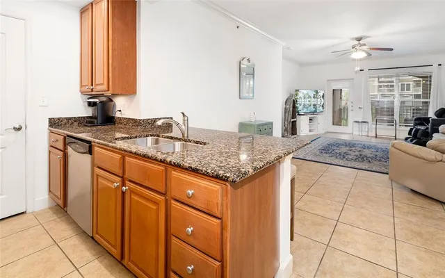 a kitchen with stainless steel appliances granite countertop a sink and a cabinets