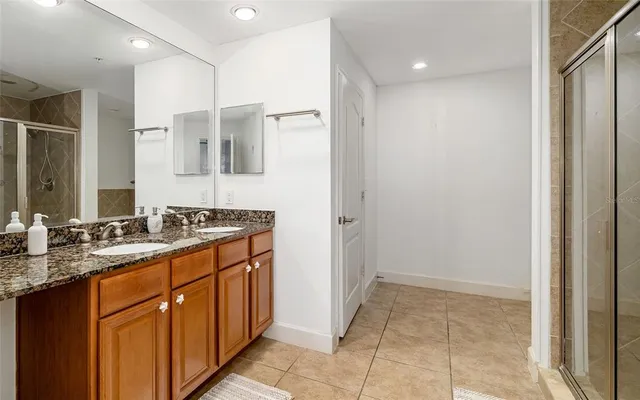 a bathroom with a granite countertop sink a mirror and a