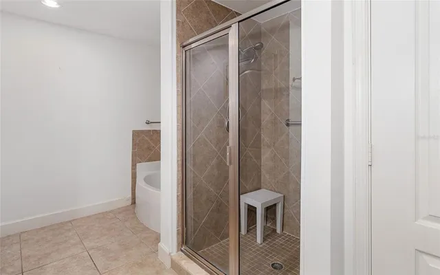a bathroom with a glass shower door