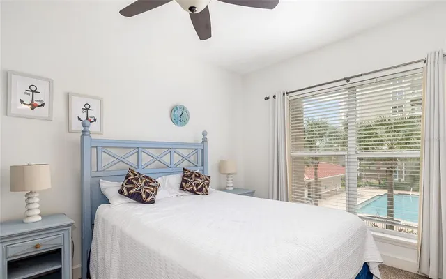 a bedroom with a large bed and a window