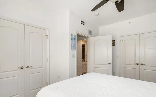 a bedroom with a bed and cabinets