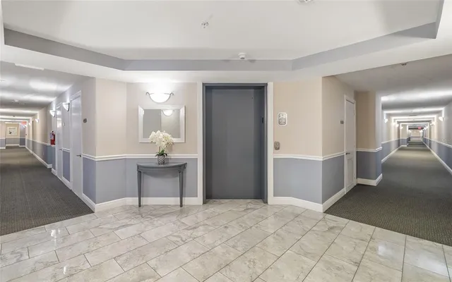 a bedroom with a bed and a large mirror