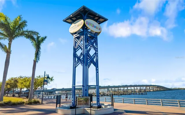 a picture of a building with glass top table and chairs