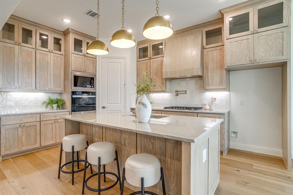 320 Slimp Bluff Azle, TX 76020 - Photo 13 of 37 a kitchen with cabinets a center island stainless steel appliances and wooden floor