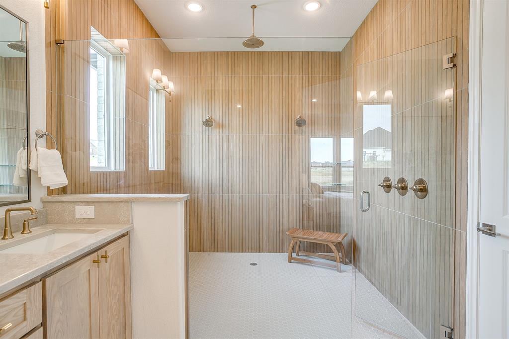 320 Slimp Bluff Azle, TX 76020 - Photo 24 of 37 a bathroom with a sink a vanity a mirror and a shower