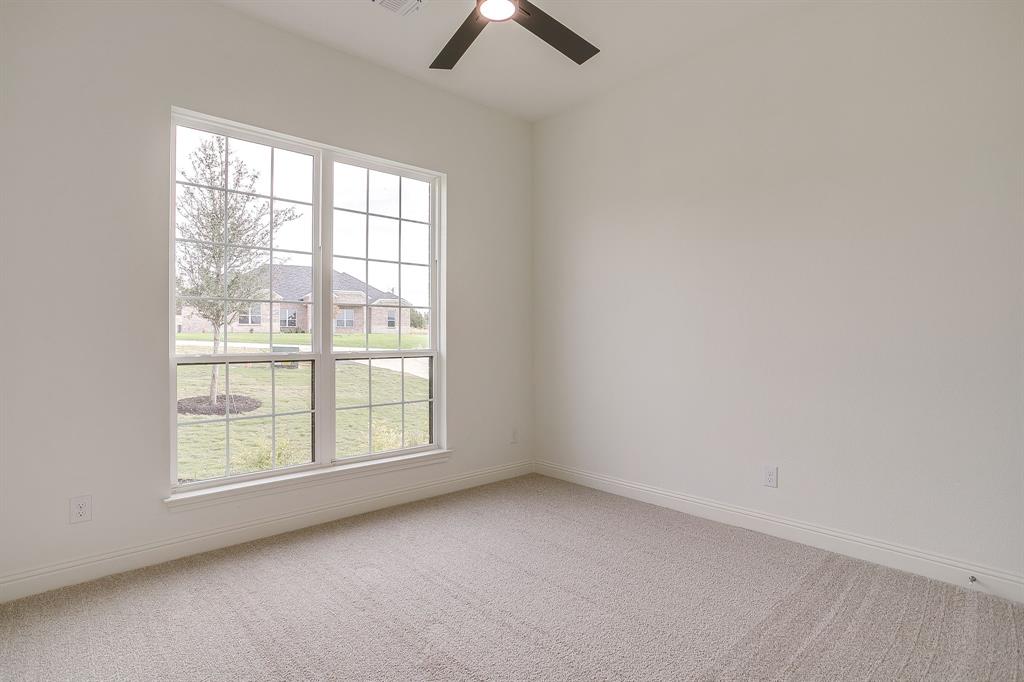 320 Slimp Bluff Azle, TX 76020 - Photo 26 of 37 an empty room with chandelier fan and windows
