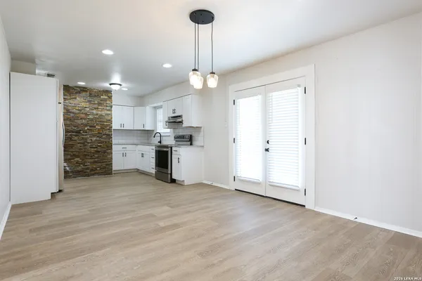 a view of kitchen with refrigerator and window