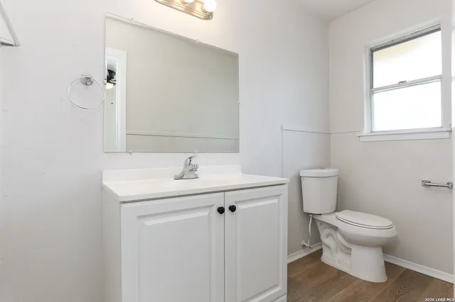 a bathroom with a toilet sink and mirror