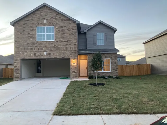 a backyard of a house with barbeque oven
