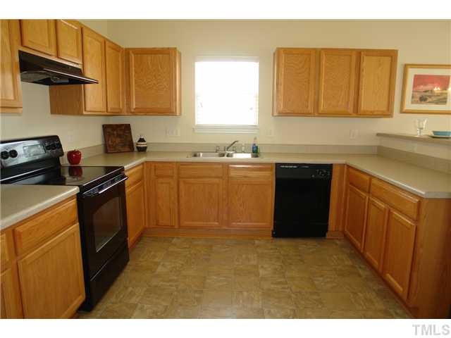 3551 Oneonta Avenue Raleigh, NC 27604 - Photo 4 of 12 a kitchen with a sink a stove and cabinets