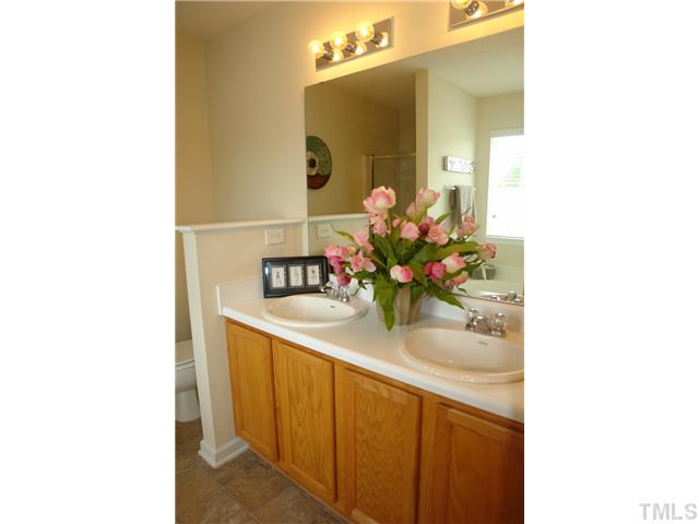 3551 Oneonta Avenue Raleigh, NC 27604 - Photo 8 of 12 a bathroom with a sink and a mirror