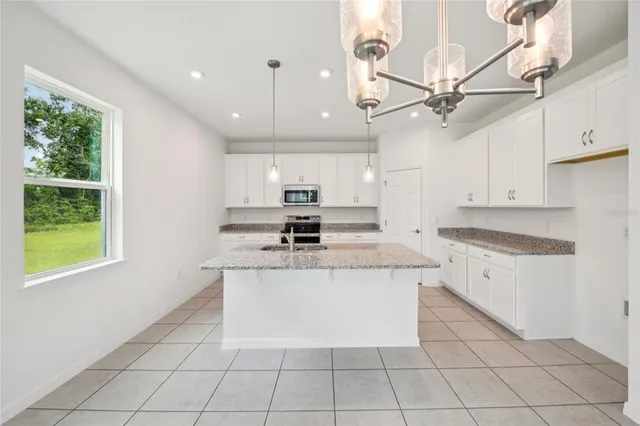 a kitchen with a stove a sink and a refrigerator