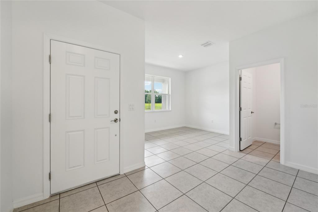 9596 Starling Loop Leesburg, FL 34788 - Photo 18 of 39 an empty room with kitchen view