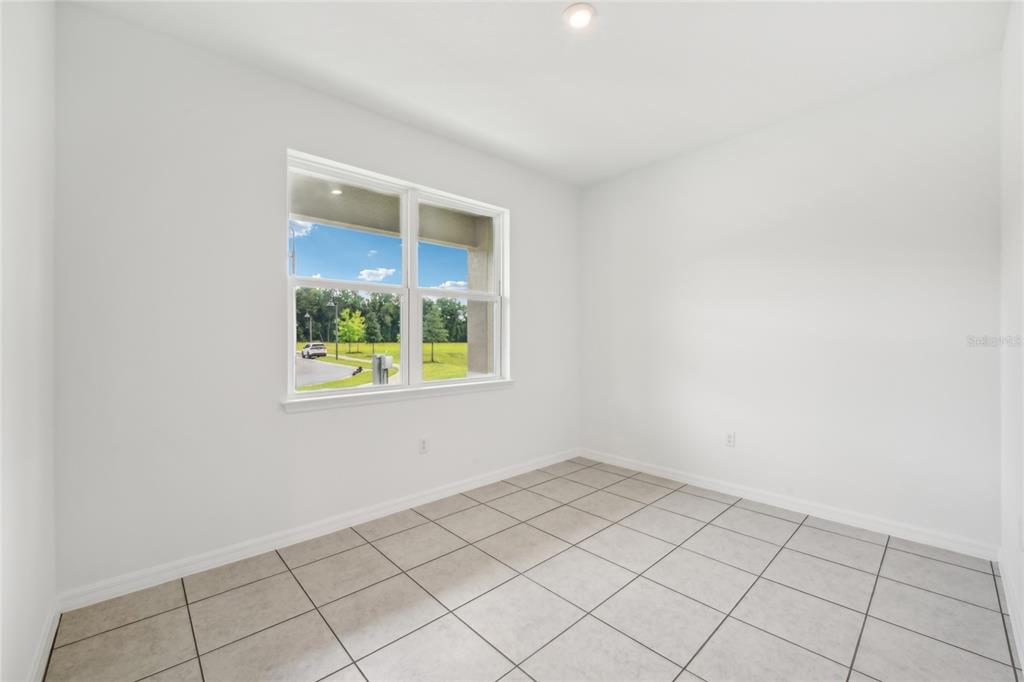 9596 Starling Loop Leesburg, FL 34788 - Photo 19 of 39 an empty room with windows