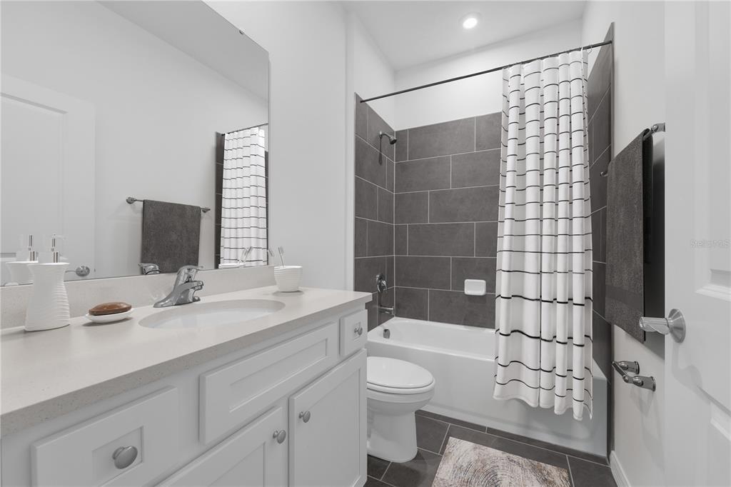 9596 Starling Loop Leesburg, FL 34788 - Photo 22 of 39 a bathroom with a sink a toilet and shower