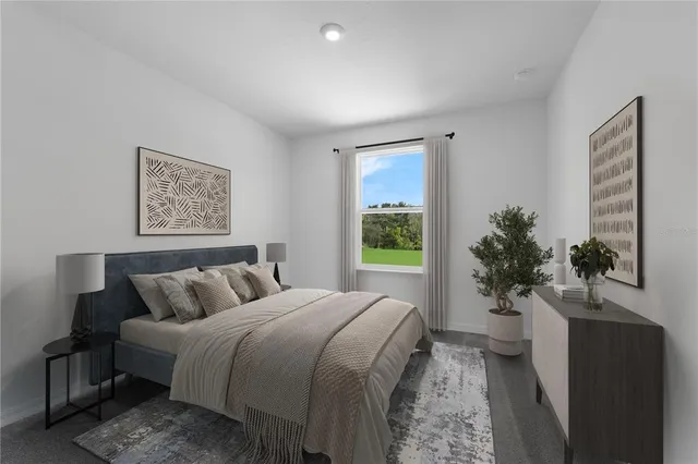 a spacious bedroom with a bed and a potted plant