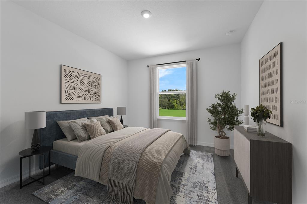 9596 Starling Loop Leesburg, FL 34788 - Photo 28 of 39 a spacious bedroom with a bed and a potted plant