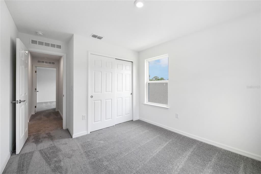 9596 Starling Loop Leesburg, FL 34788 - Photo 33 of 39 an empty room with windows