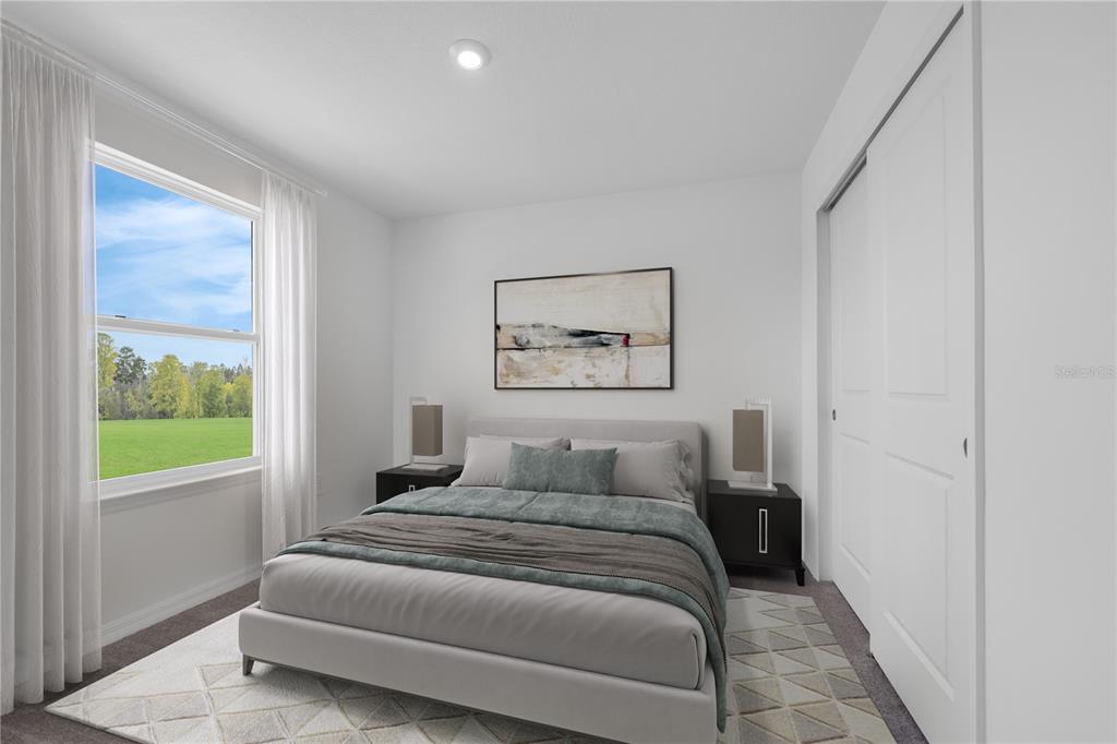 9596 Starling Loop Leesburg, FL 34788 - Photo 34 of 39 a bedroom with a bed and a painting on the wall