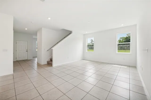 an empty room with windows and closet