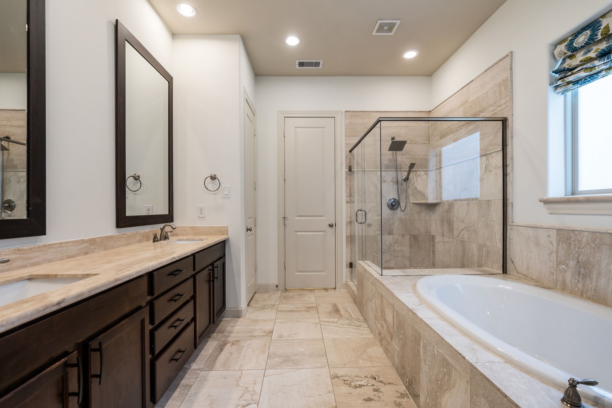 1103 Summer Street Houston, TX 77007 - Photo 16 of 30 A spa-like ensuite bath outfitted with dual sinks, a luxurious walk-in shower, and a separate soaking tub.