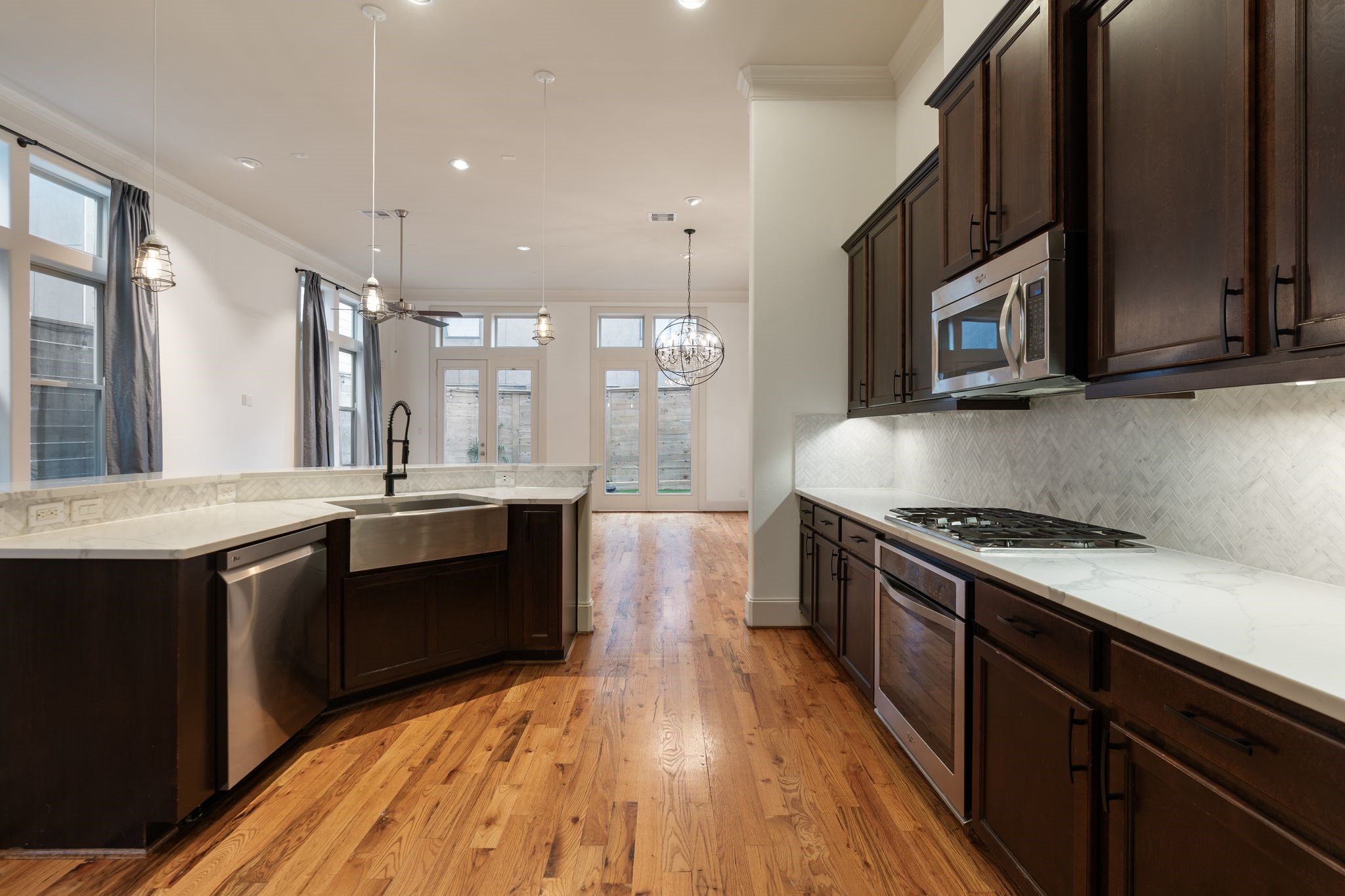 1103 Summer Street Houston, TX 77007 - Photo 5 of 30 This updated kitchen is a dream, featuring quartz countertops, premium appliances, and rich wood cabinetry.