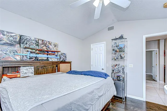 a bedroom with bed and a chandelier