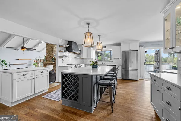 a large kitchen with a table and chairs