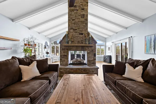 a view of an empty room with a fireplace and a window
