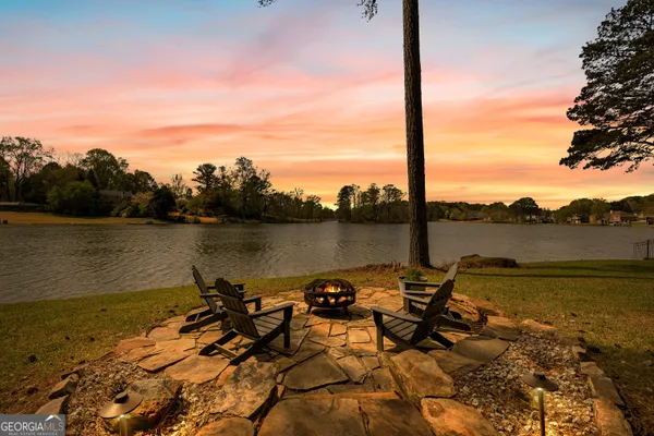 a kitchen with stainless steel appliances granite countertop a sink a stove and a wooden floors